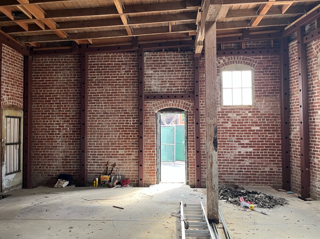 Interior looking east, rehabilitated wall and updated structural framing